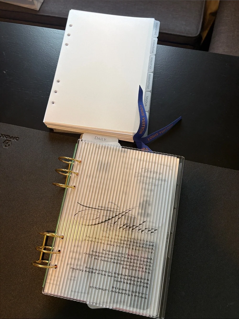 A5 Planner Pages with Blue Ribbon and Gold Rings.